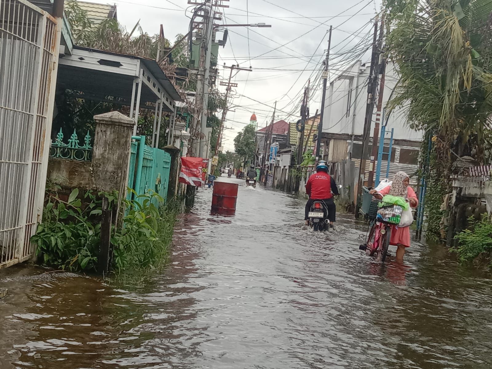 Jalan Tambrin Bnajarmasin Selatan Tmpak Masih Tergenang Air dan Pengendara Tetap Beraktifitas