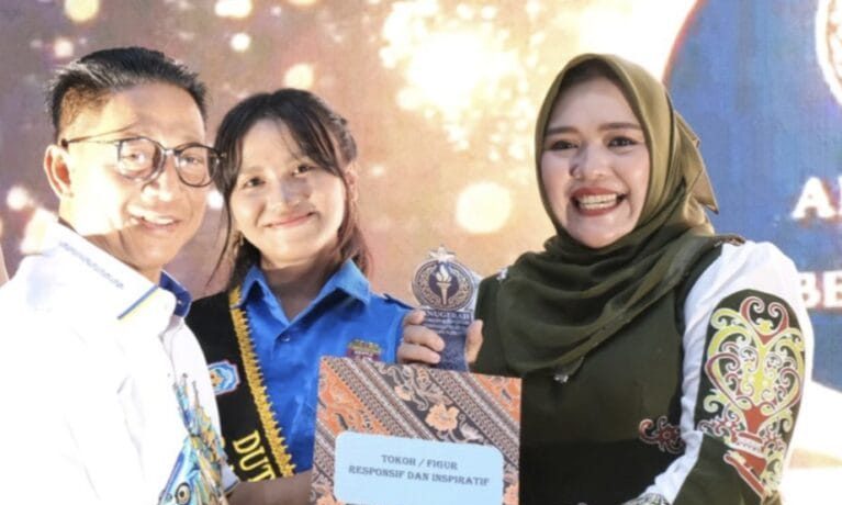 Dina Maulidah saat menerima penghargaan dari Bupati Heriyus (foto: istimewa)