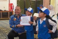 Pemerintah Kabupaten Kotabaru melalui Dinas Pendidikan dan Kebudayaan secara simbolis menyerahkan bantuan berupa baju seragam sekolah dan perlengkapan sekolah