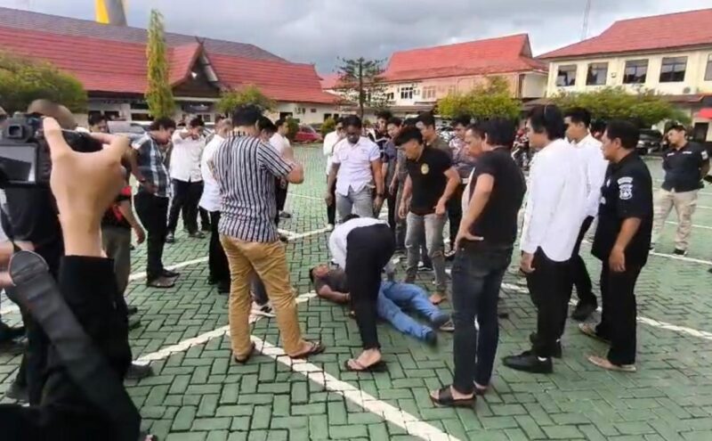 PRIA NGAMUK - Seorang pria diamankan sejumlah anggota saat mengamuk di halaman Mapolresta Banjarmasin, Senin (30/3/2026) siang 
